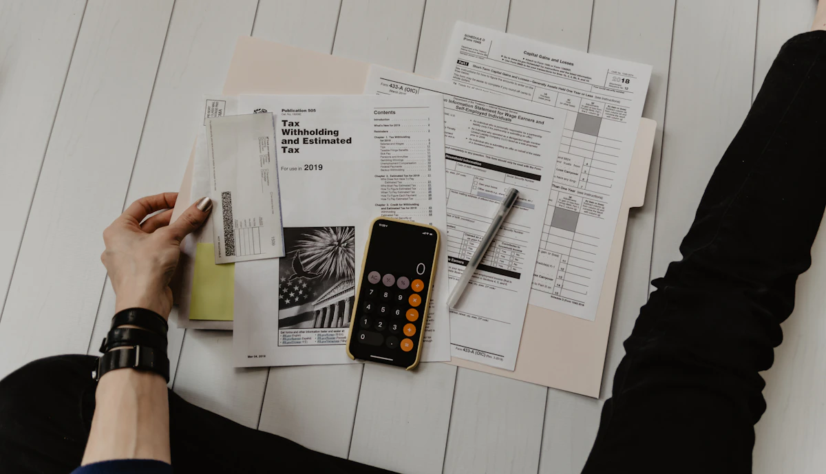 Calculating UAE business setup costs with a calculator and documents